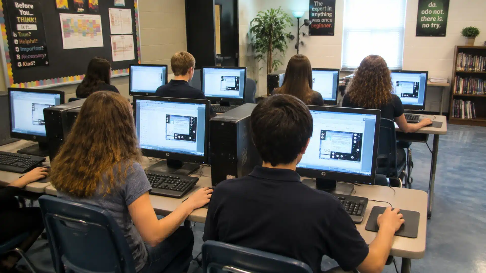 students taking digital sat adaptive test on laptops in rows at a classroom testing center desk