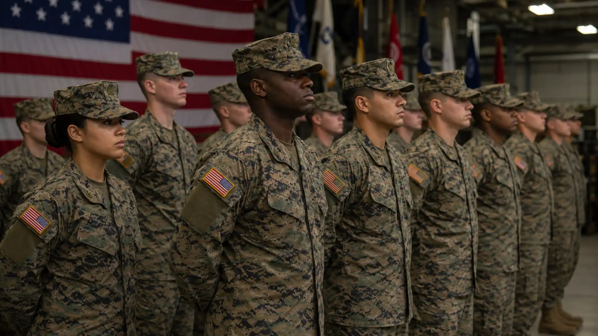 group of u.s. military recruits standing in formation during basic training inside a military facility