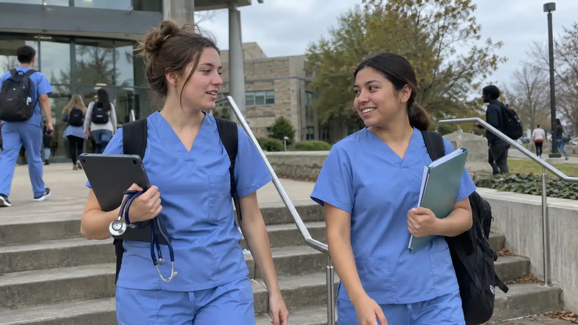 nursing students walking together on campus with clinical gear