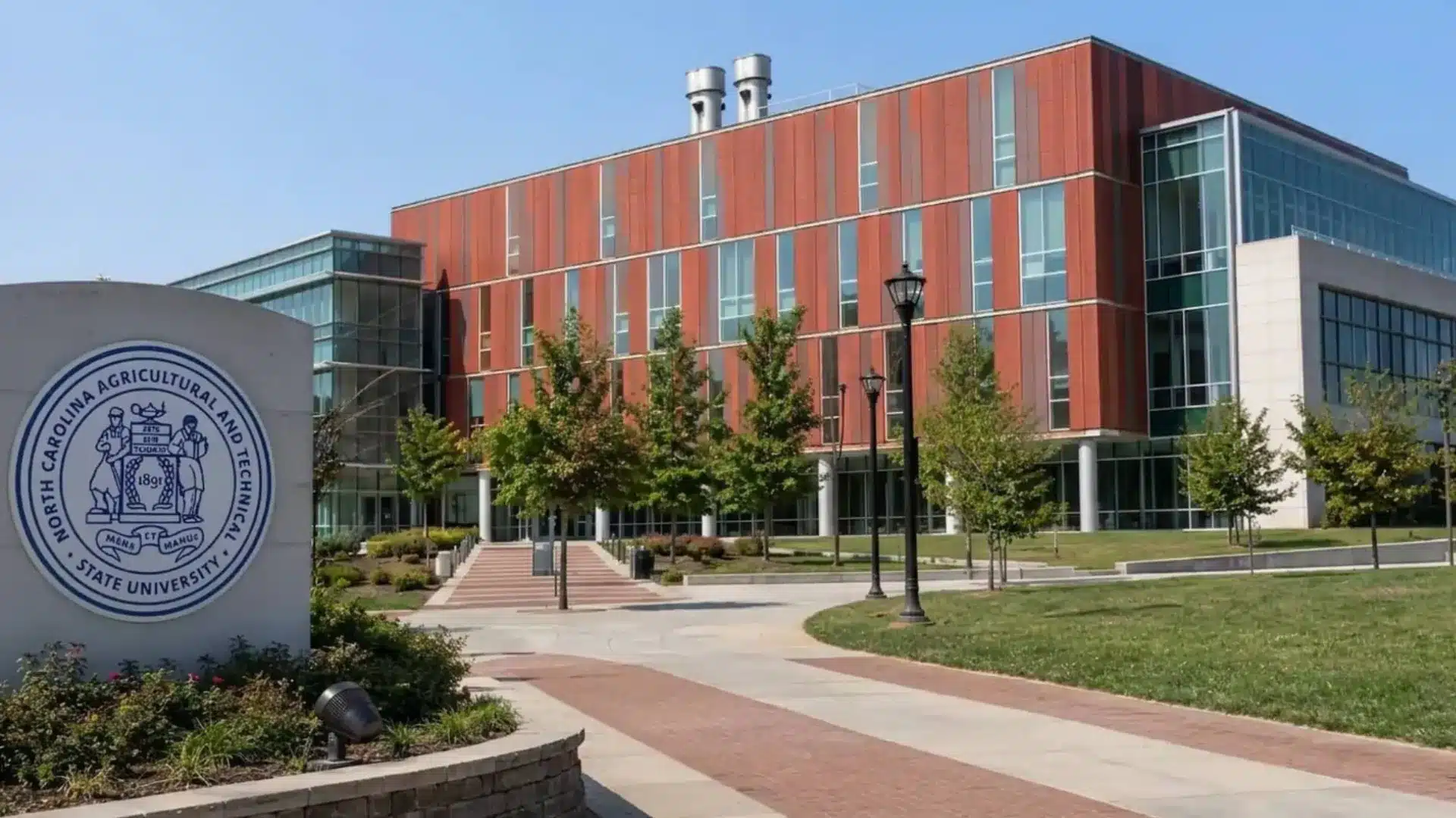 north carolina a&t state university campus building with modern architecture and green lawn walkway