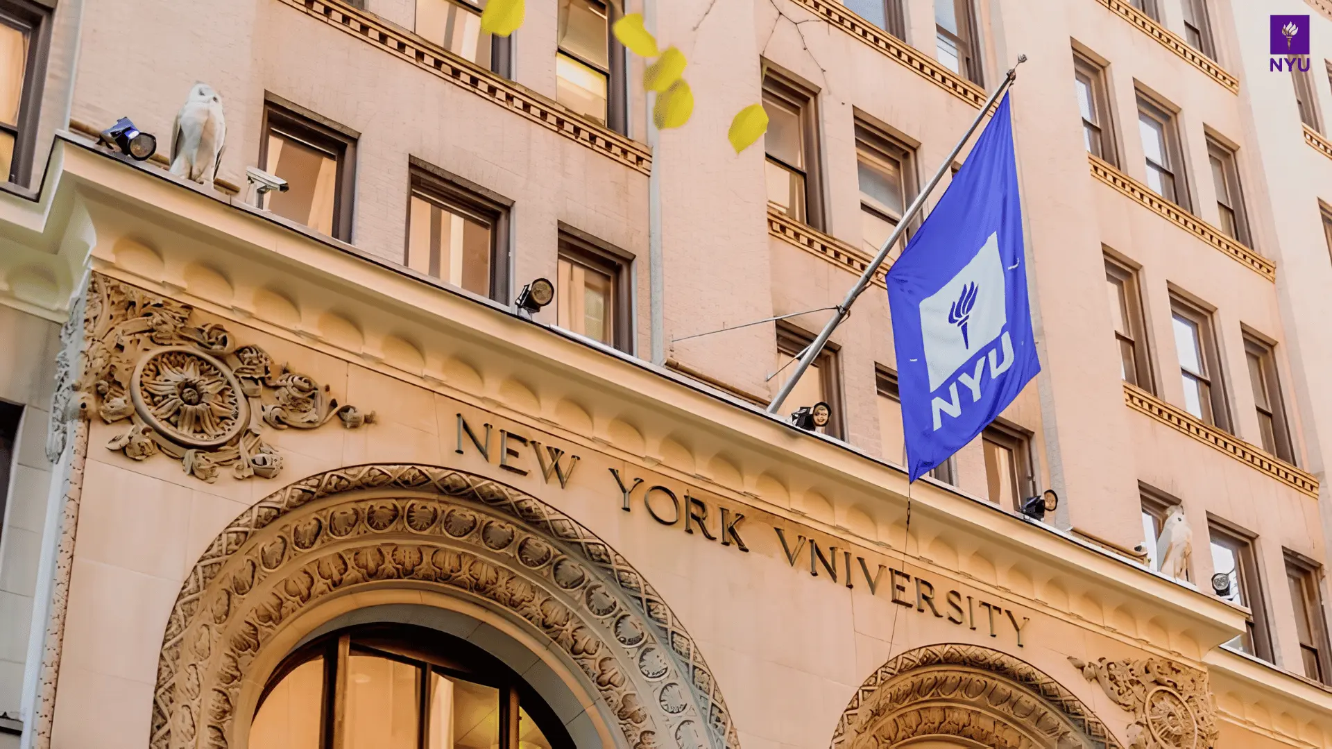 nyu building facade with New York University carved in stone, an owl statue on the ledge, and a blue NYU flag