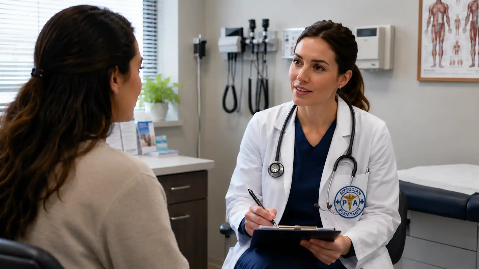 physician assistant consulting with a patient in a medical exam room while taking notes on a clipboard and wearing a white coat