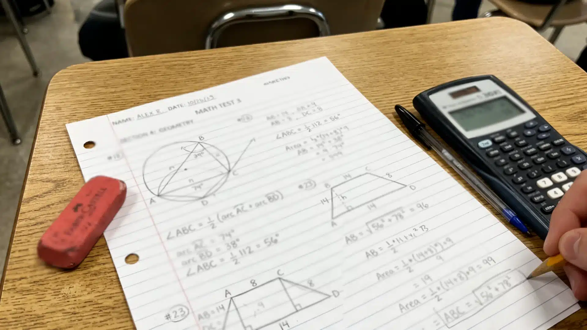 a practice test with circle and triangle diagrams, handwritten calculations, a calculator, pencil, pen, and red eraser on a desk